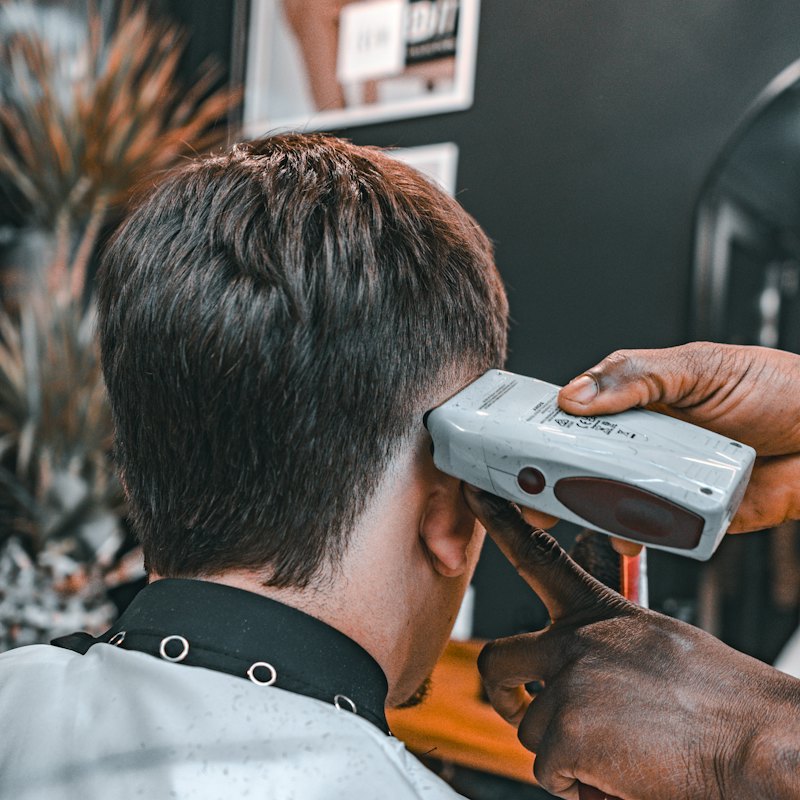 A man getting a haircut in a barber chair